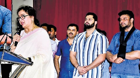 Mandya MP Sumalatha Ambareesh addresses her supporters, as her son Abishek Ambareesh and Kannada superstar Darshan look on, in Mandya on Wednesday