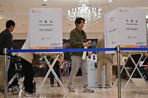 South Koreans cast their ballots during the parliamentary elections at a polling station located in a wedding hall in Seoul on April 10, 2024. 
