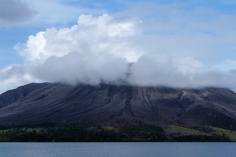 The Mount Ruang volcano spews smoke