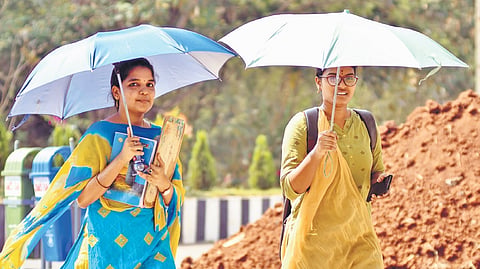 Holding umbrellas, two girls ventured out in Vijayawada.