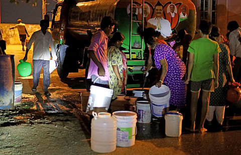 People collecting drinking water from a water tank at Rajarajeswari Nagar in Bengaluru. 