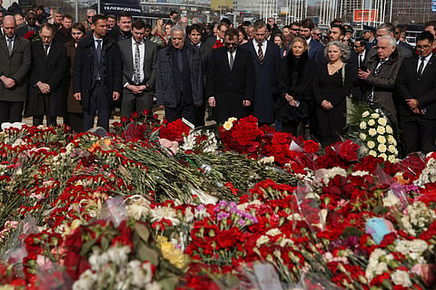 Ambassadors and representatives of diplomatic missions accredited in Russia stand at attention as they attend a flower laying ceremony at the memorial in memory of the victims of the terrorist attack at the Crocus City Hall concert venue a week after the attack in Krasnogorsk, outside Moscow on March 30, 2024. 