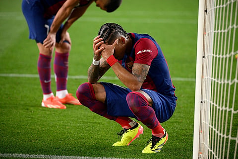 Barcelona's Brazilian forward #11 Raphinha reacts at the end of the UEFA Champions League quarter-final second leg football match between FC Barcelona and Paris SG at the Estadi Olimpic Lluis Companys in Barcelona on April 16, 2024. 