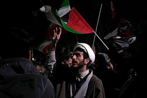 A cleric chants slogans during an anti-Israeli gathering in front of the British Embassy in Tehran, Iran, early Sunday, April 14, 2024. 