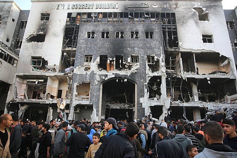 Palestinians inspect the damage outside Gaza's Al-Shifa hospital after the Israeli military withdrew from the complex housing the hospital on April 1, 2024, amid the ongoing battles Israel and the Hamas militant group.