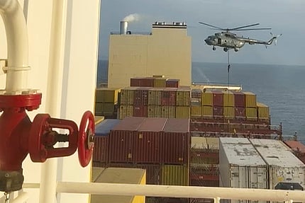 This image made from a video provided to The Associated Press by a Mideast defense official shows a helicopter raid targeting a vessel near the Strait of Hormuz on Saturday, April 13, 2024. 