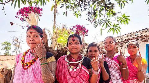 Baiga tribal women show their fingers marked with indelible ink after casting their votes for the first phase of Lok Sabha elections, in Dindori district in Madhya Pradesh 