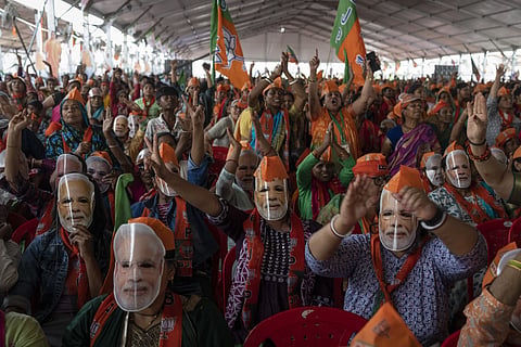 Bharatiya Janata Party (BJP) supporters wear masks of Indian Prime Minister Narendra Modi during an election rally addressed by Modi in Meerut, India, Sunday, March 31, 2024. 