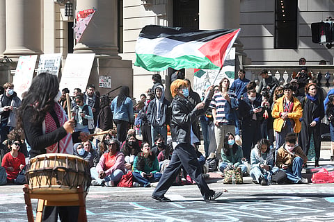 Several hundred students and pro-Palestinian supporters rally at the intersection of Grove and College Streets.