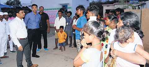 Palnadu district Collector Sivashankar Lotheti explaining the importance of adult franchise to tribals during ‘Palle Nidra’ programme 