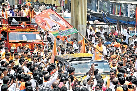 BJP Chevella candidate Konda Vishweshwar Reddy waves the party flag during 
a rally in Rajendranagar on Monday. 