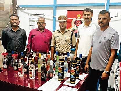 RPF officers with seized liquor bottles, smuggled through trains 