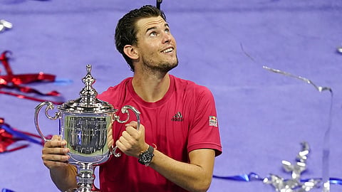 Dominic Thiem, of Austria, holds up the championship trophy after defeating Alexander Zverev, of Germany in the men's singles final of the US Open tennis championships, Sunday, Sept 13, 2020, in New York. 