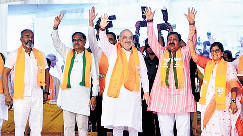 Union Home Minister Amit Shah greets the gathering during an election campaign at Hukkeri in the Chikkodi Lok Sabha segment on Friday | Express