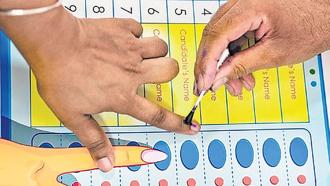 A voter gets her finger marked with indelible ink before casting her vote at Dr. Rajendra Prasad Kendriya Vidyalaya, President’’s Estate.