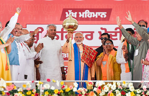 PM Modi with a mace at the Hoshiarpur rally, Punjab.