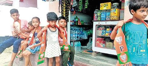 Children donning BJP scarves at a roadside tea shop in Varanasi, PM’s constituency 