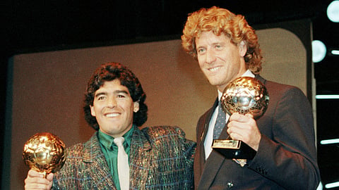 Argentina's soccer star Diego Maradona, left, and West German goalkeeper Harald Schumacher are holding their World Cup Soccer Ball awards during the Soccer Golden Shoe Award ceremony held in Paris, France, on Nov. 13, 1986. 
