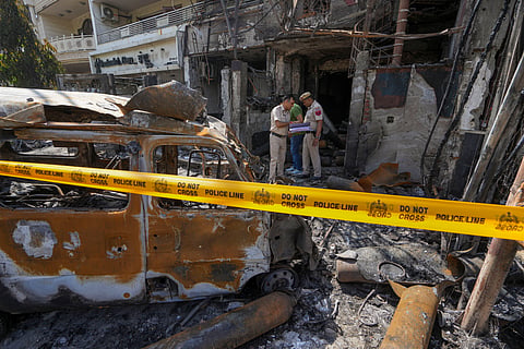 Policemen outside a children's hospital where a fire broke out on Saturday night at Vivek Vihar area, in New Delhi, Sunday, May 26, 2024. 