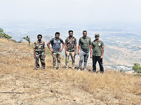 Madukkarai forest range officer Arun Kumar and team camping on a hillock to prevent forest fires 