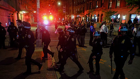 Members of the New York Police Department strategic response team move towards an entrance to Columbia University, Tuesday, April 30, 2024, in New York.