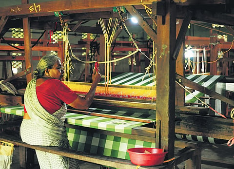 Weavers working on the loom at the Chendamangalam Cooperative Society Centre 