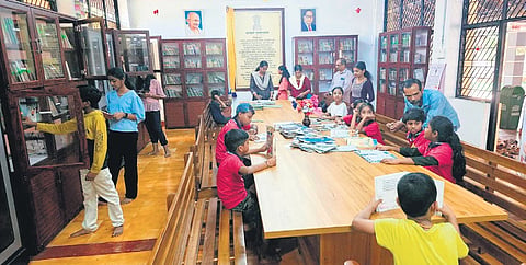 Students and teachers of Mattannur Madhusoodanan Thangal Smaraka UP School reading books in the newly constructed library