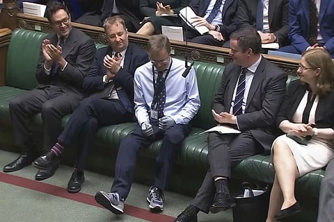 Craig Mackinlay, Conservative MP for South Thanet, is applauded by members of parliament as he returns to the House of Commons for the first time since he was rushed into hospital with sepsis on September 28, which left him with both of his hands and feet amputated, at the Parliament in London, Wednesday, May 22, 2024.