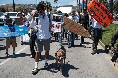 Members of the surfing community protest against insecurity after two Australians and an American surfers went missing last week during a surfing trip in Mexico, on May 5, 2024.