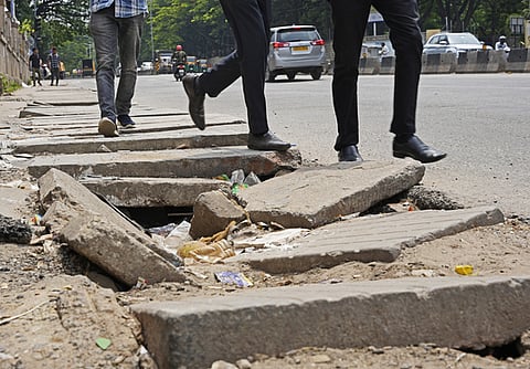 Pedestrians forced to walk on road due to broken footpath slabs in Bengaluru