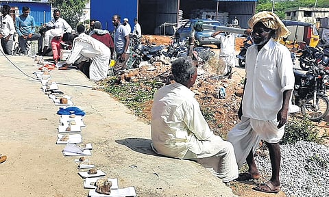 Farmers keep passbooks to reserve their place in the queue and wait for their turn to receive Jeeluga seeds in Andole of Sangareddy district on Tuesday.
