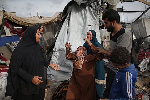 Displaced Palestinians inspect their tents destroyed by Israel's bombardment, adjunct to an UNRWA facility west of Rafah city, Gaza Strip, Tuesday, May 28, 2024. 