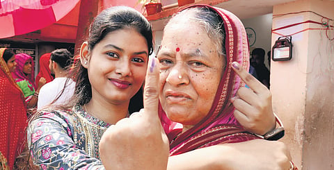 A first-time voter with grandma at a polling booth in Aska, Odisha.