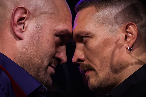 Britain's Tyson Fury (L) and Ukraine's Oleksandr Usyk (R) face off during a press conference in London on November 16, 2023, ahead of their undisputed heavyweight world championship contest scheduled to take place in Riyadh, Saudi Arabia. 