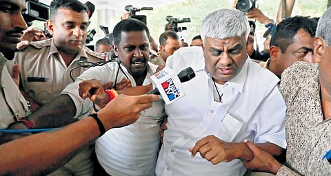 SIT officers take JDS MLA HD Revanna inside Bowring Hospital for a medical 
check-up, in Bengaluru on Sunday. 