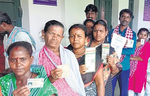 Voters wait in line to cast their vote