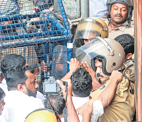 Police personnel block protesters led by the KSU Idukki district committee during a march to the DDE office in Thodupuzha 
over the alleged Plus-I seat shortage on Monday 