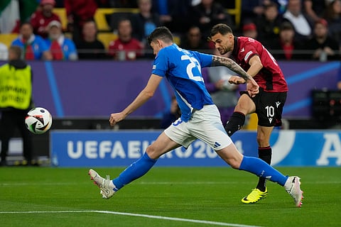 Albania's Nedim Bajrami, back, scores his side's opening goal during a Group B match between Italy and Albania at the Euro 2024 soccer tournament on June 15, 2024. 