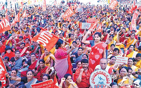 Anganwadi workers stage a protest demanding that the state government start kindergarten classes in anganwadis,in Bengaluru on Monday.