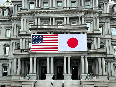 US and Japanese flags are seen posted on the Eisenhower Executive Office Building next to the White House in Washington