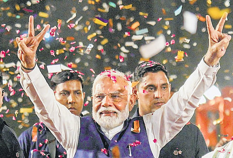 Narendra Modi greets supporters in New Delhi on Tuesday