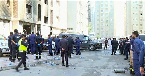 Rescuers arrive at the site of a building that caught fire in Kuwait, Wednesday, June 12, 2024.