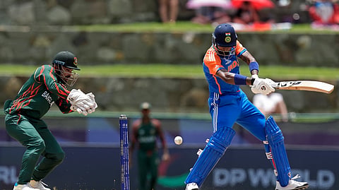 India's Hardik Pandya, right, plays a shot during the ICC Men's T20 World Cup cricket match between India and Bangladesh at Sir Vivian Richards Stadium in North Sound, Antigua and Barbuda, Saturday, June 22, 2024. 