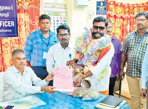 One of the aspirants came with a garland of cash amounting to `50,000 and coins worth `10,000 in a bag to depict that election had become ‘a business’