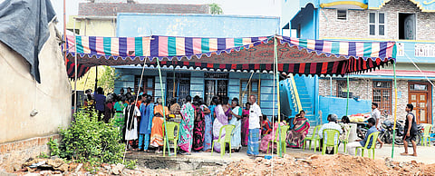 A purple tent mounted in front of a house in Karunapuram 