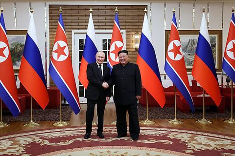 Russian President Vladimir Putin, left, and North Korea's leader Kim Jong Un pose for a photo after the official welcome ceremony in Pyongyang, North Korea.