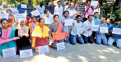 Teaching job aspirants stage a protest kneeling down outside the residence of Chief Minister A Revanth Reddy on Wednesday
