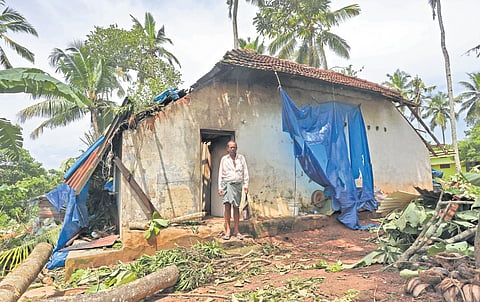 Najeeb R standing in front of his damaged house at Thazhe Vettoor near Varkala 
