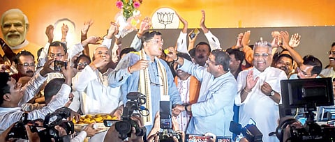 Jubilant BJP leaders Dharmendra Pradhan, Baijayant Panda and Union minister Bhupendra Yadav seen celebrating their victory with sweets in Bhubaneswar on June 4.
