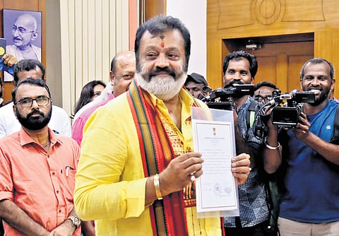 Suresh Gopi with the certificate proclaiming his victory from Thrissur 